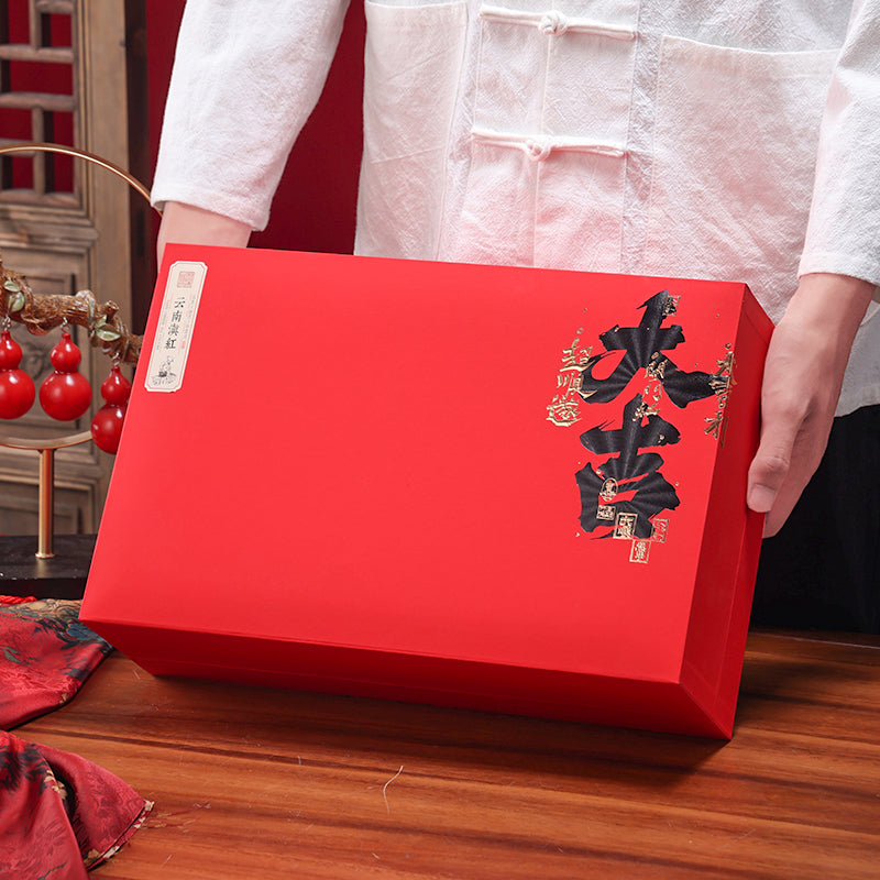 Premium Yunnan Dian Hong black tea gift box in elegant red packaging with Chinese calligraphy, ideal for gifting authentic Chinese black tea on holidays, celebrations, or special occasions.
